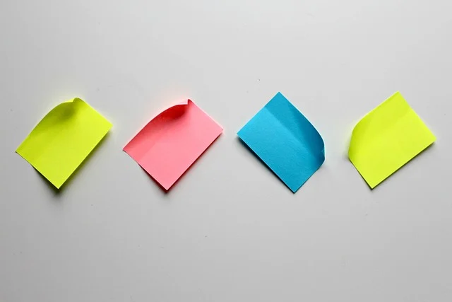 Four colorful sticky notes lined up on a white surface