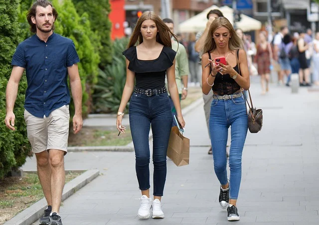 Kanji Oversized T Shirt: People walking on a city street wearing casual everyday outfits