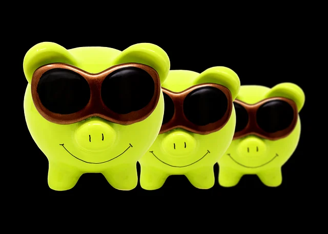Three green piggy banks wearing sunglasses lined up in a row