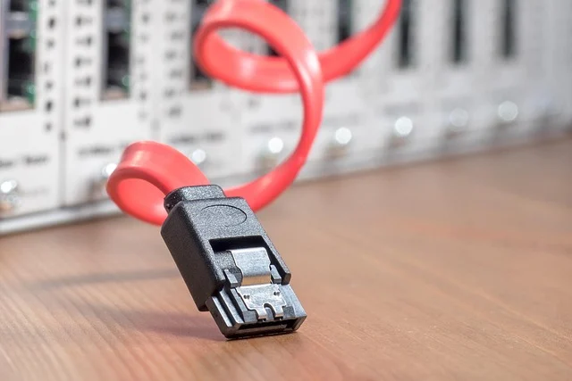A red SATA cable next to server infrastructure equipment