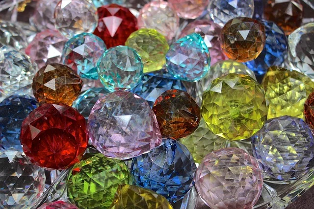 A collection of colorful faceted gemstones or crystal beads
