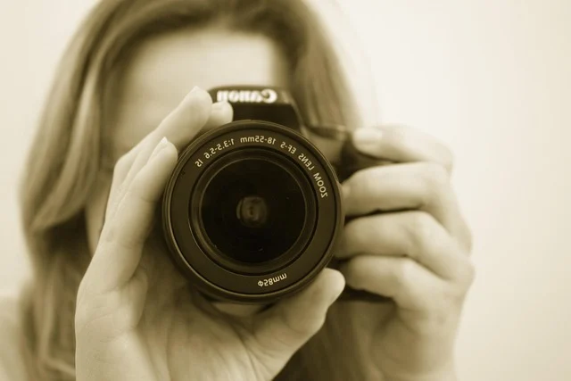 A person holding a camera pointing the lens forward