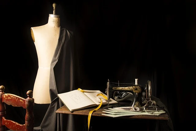 A tailor mannequin, vintage sewing machine, fabric, and measuring tape