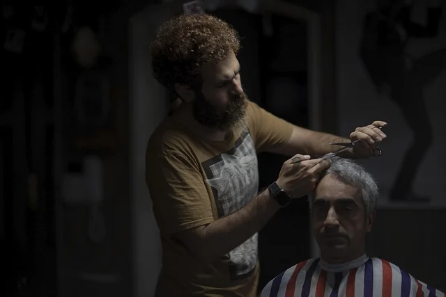 Barber Shop Barista To Multi Business Owner With Darvin Sejdic: A barber cutting hair for a client in a shop