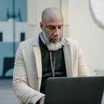 man working in warehouse then in office