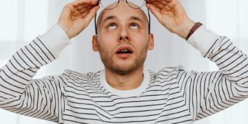 person looking stressed at desk