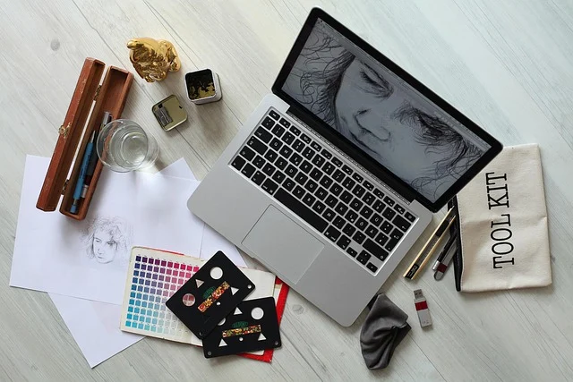 ANARCHY Logo Black Goth 100x@2x.png: A laptop on a desk surrounded by art and design supplies