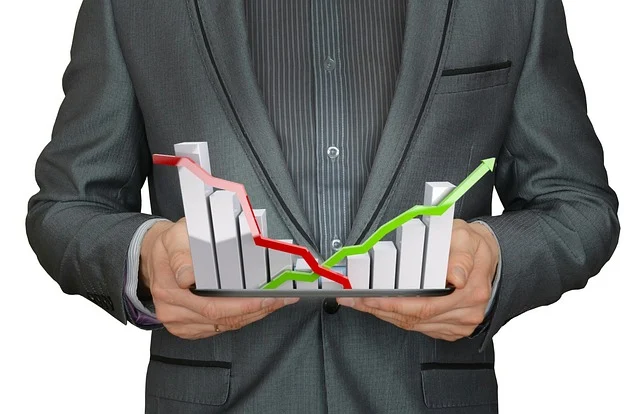A businessman holding a 3D growth bar chart