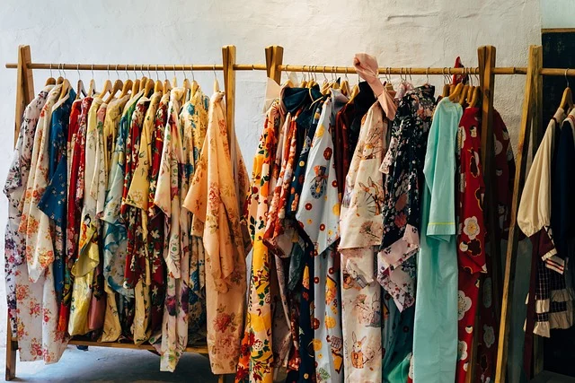 Colorful patterned clothes hanging on wooden clothing racks