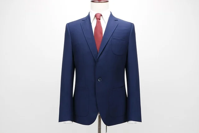A blue suit jacket and red tie on a mannequin