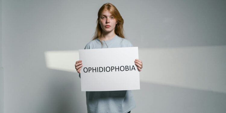 woman holding gold clutch