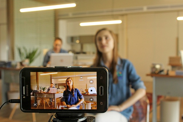 A woman being filmed on a smartphone for video content creation