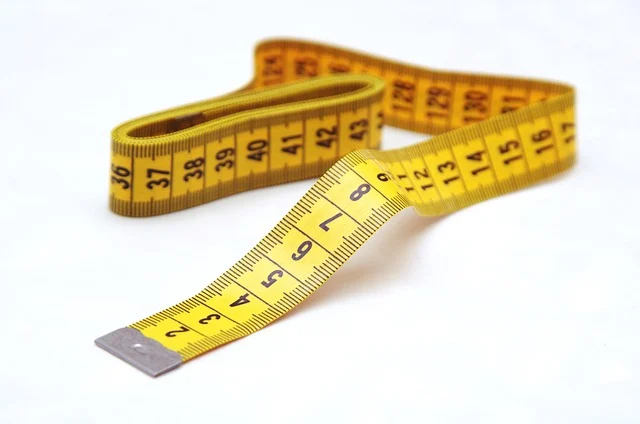 A yellow measuring tape on a white background