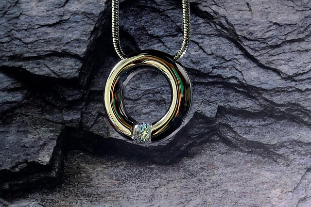 A metallic ring pendant with a gem on a chain