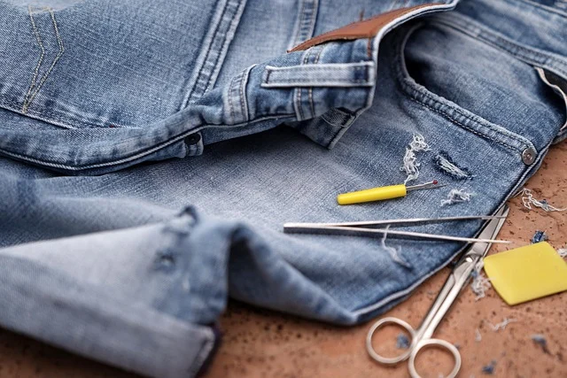 Close-up of denim fabric with subtle distressing and fraying