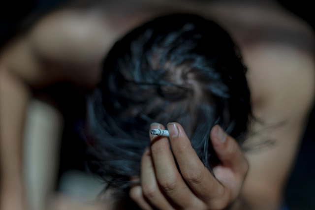 Close-up of a person's hands layering a jacket over a sweater