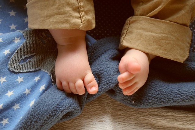 Close-up of a person's legs showing the proper hem length of boot cut jeans over ankle boots.
