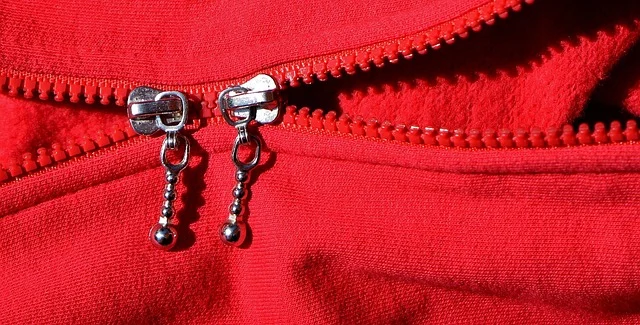 Close up of double zipper on a red zip up hoodie