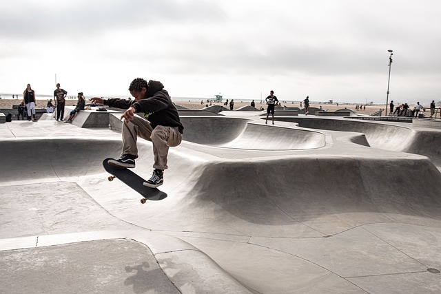 A skateboarder performing a trick mid-air at a skatepark