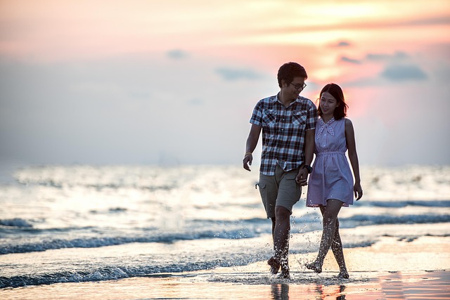 Couple holding hands while wearing casual, comfortable outfits for a movie date.
