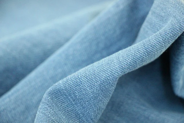 Close-up texture of folded blue denim fabric