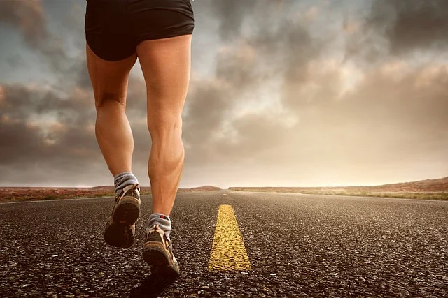 A person running on an open road wearing running sneakers