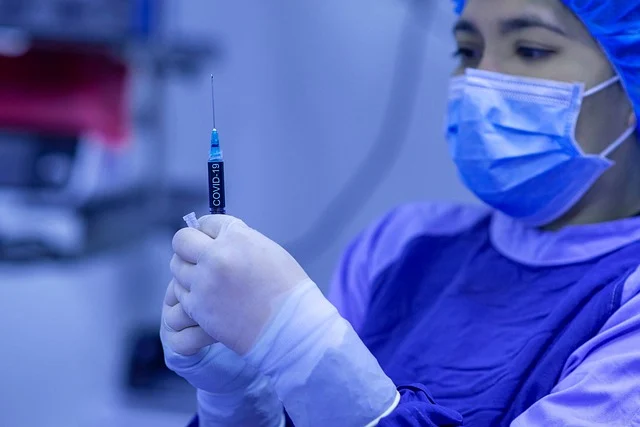 A medical worker holding a syringe