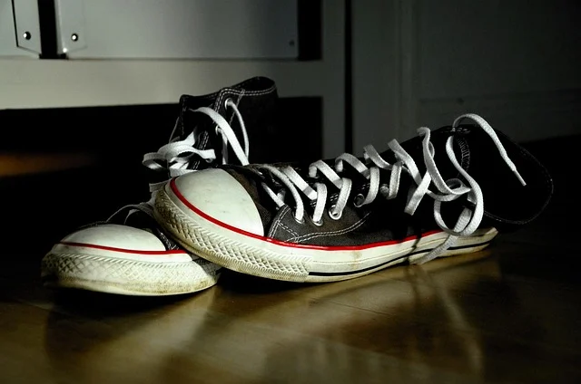 Pair of black canvas sneakers with dirty white rubber toe caps