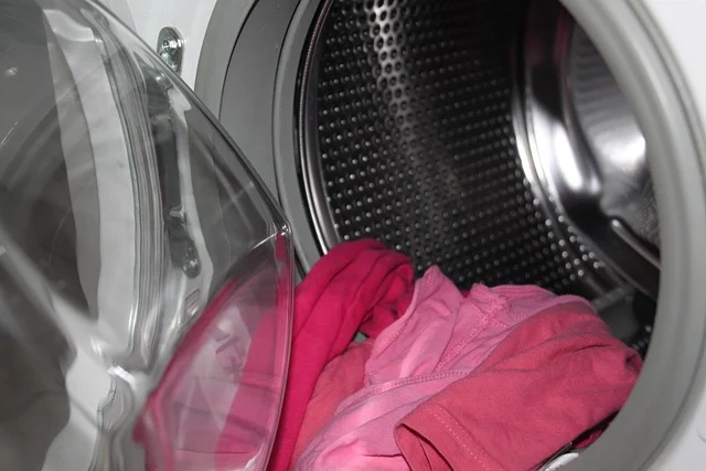 Clothes inside an open front-loading washing machine drum