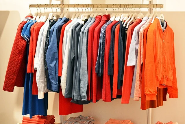 Colorful shirts and jackets hanging on a clothing rack in a store