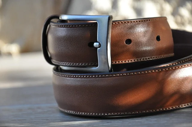 Luxury leather belt stored flat in a dust bag