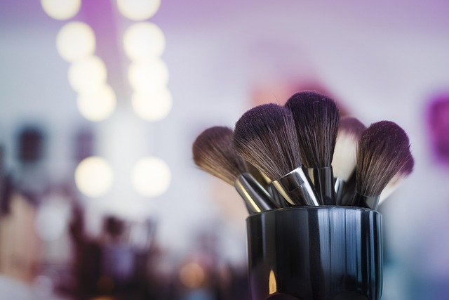 Makeup artist applying foundation with a damp sponge