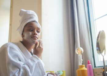 person applying face serum