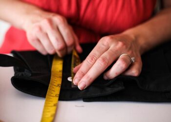 person hemming wide leg jeans