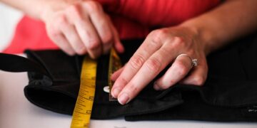 person hemming wide leg jeans