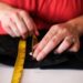 person hemming wide leg jeans