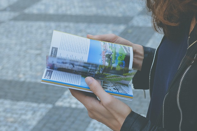 A person reading a book in a comfortable armchair