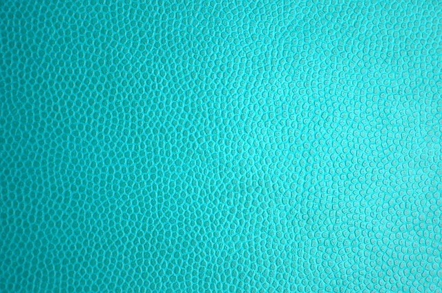 Close-up view of bright turquoise textured leather material