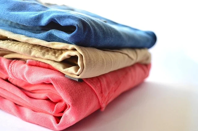 A stack of folded colorful jeans and pants