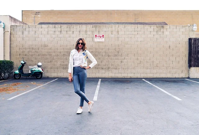 A woman wearing a casual streetwear outfit with sneakers outdoors