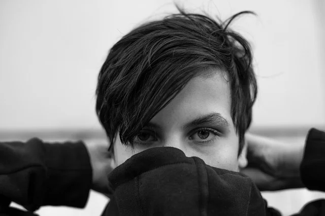Black and white portrait of a person in a hoodie