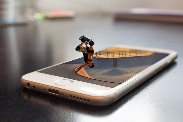A miniature skateboarder performing a trick popping out of a smartphone screen