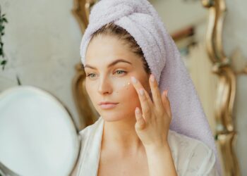 woman applying face serum