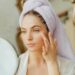 woman applying face serum