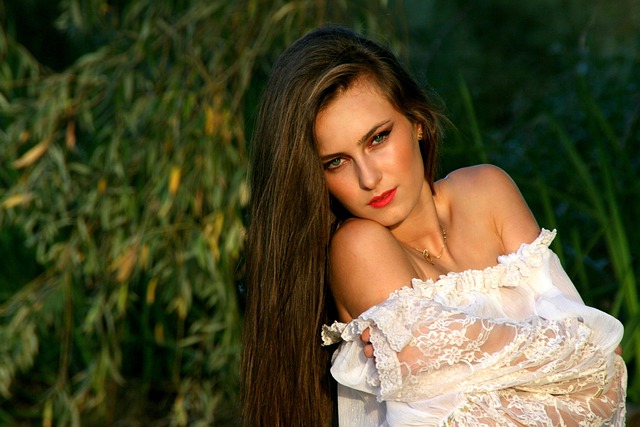 Woman with elegant makeup and hair, wearing a gold dress