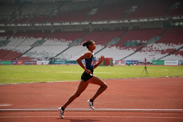 Woman lacing up running shoes, showing detail of performance running tank top (best running tank tops for women)