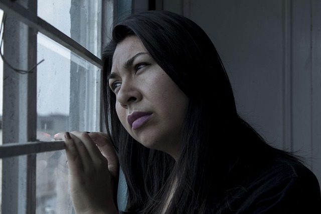Woman looking stressed while staring at a closet full of clothes, with Amazon packages in the background