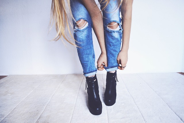 Woman styling denim womens overalls with a striped t-shirt and a denim jacket