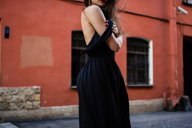 Woman wearing black Mary Jane heels with white ankle socks and a midi skirt.