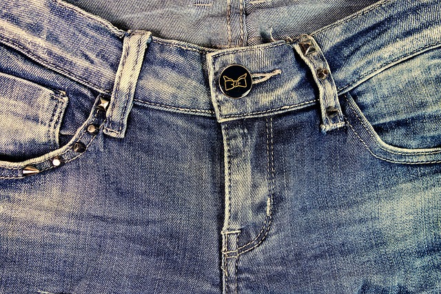 Woman wearing blue kitten heels with cropped jeans and a white blouse.
